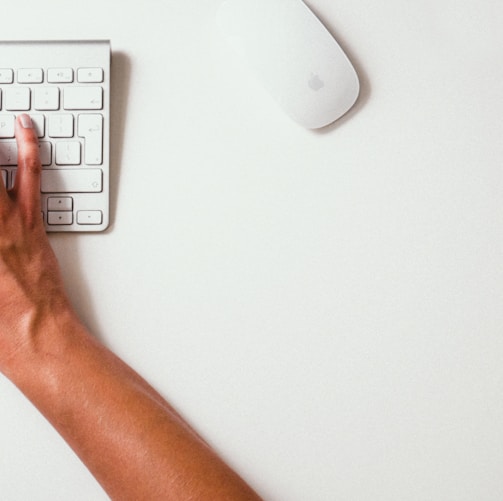 person typing on Apple Cordless Keyboard