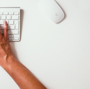 person typing on Apple Cordless Keyboard