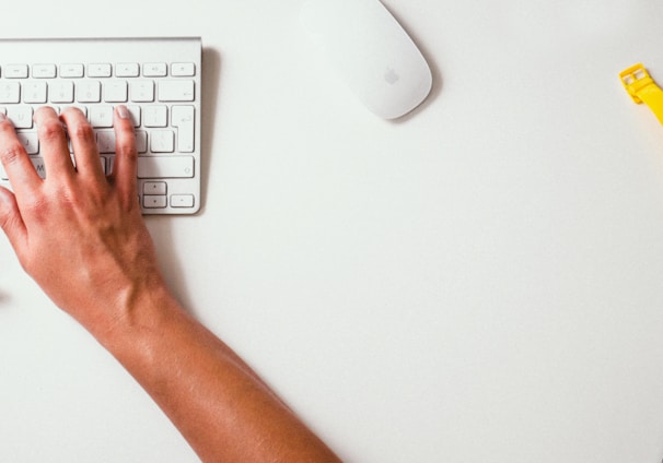 person typing on Apple Cordless Keyboard