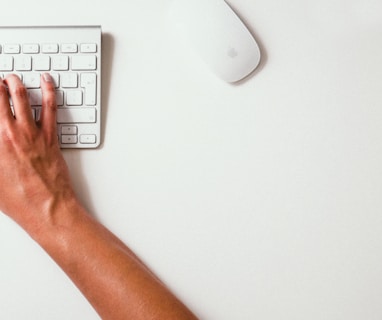 person typing on Apple Cordless Keyboard