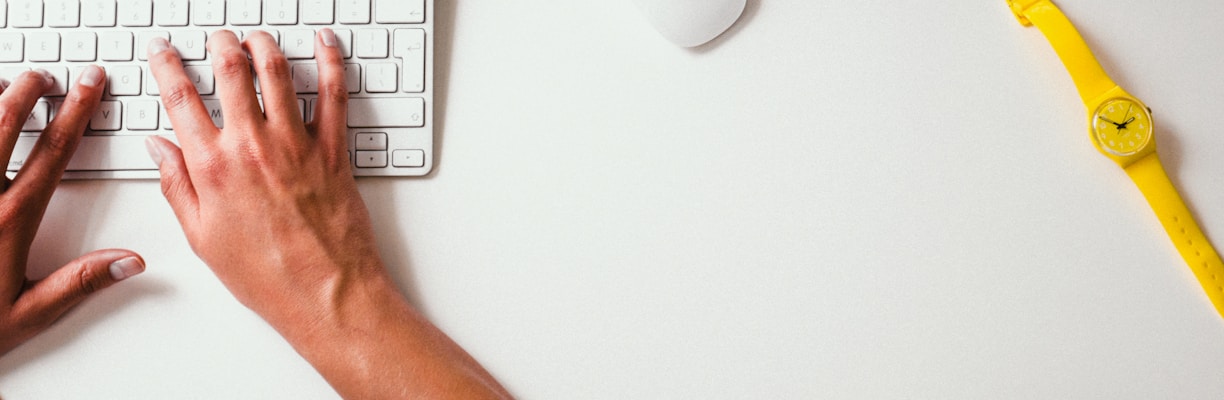 person typing on Apple Cordless Keyboard