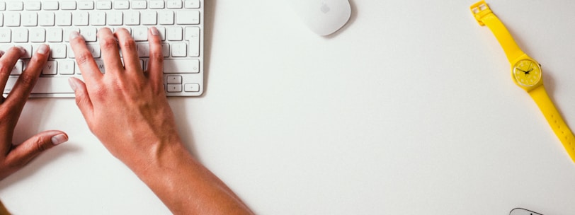 person typing on Apple Cordless Keyboard