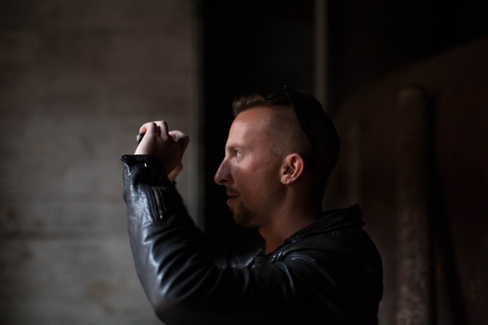 man wearing black leather jacket