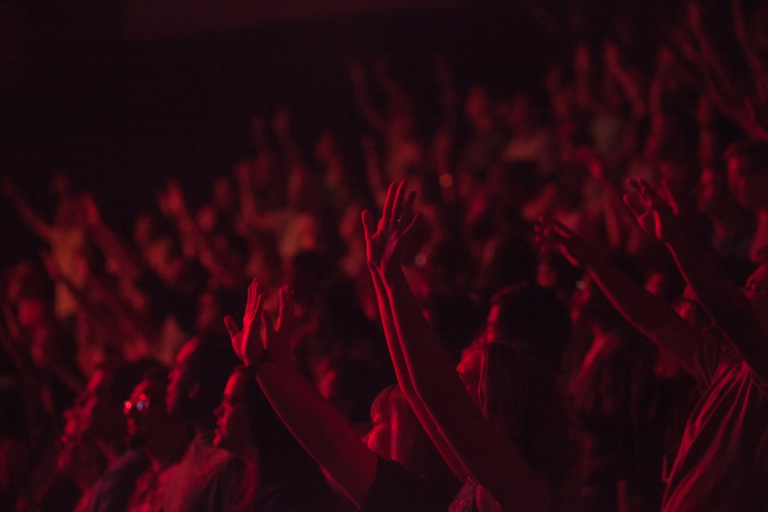 crowd lifting their hands watching concert, Cheering crowd at a concert