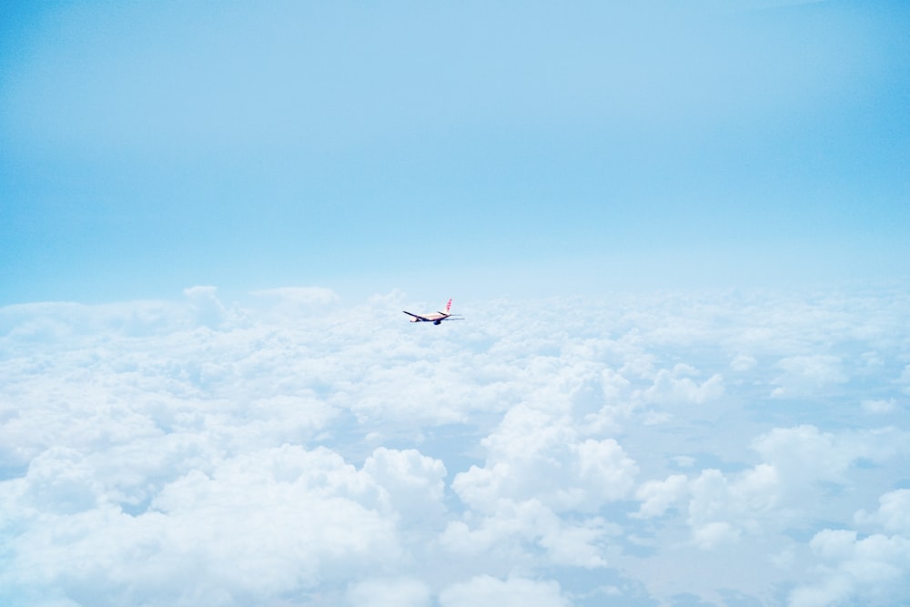 flying airplane above clouds