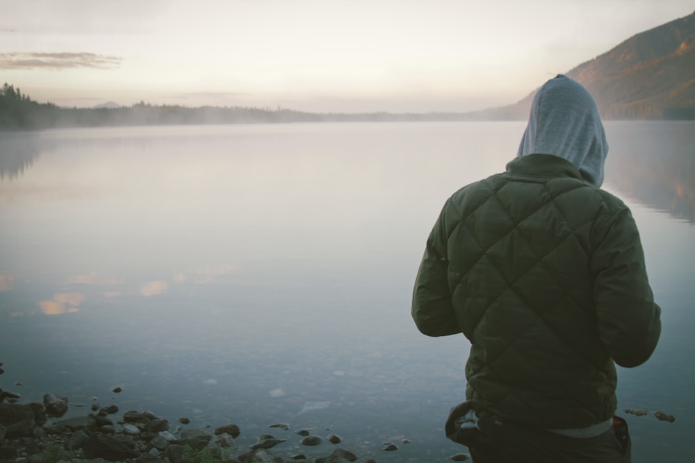 person in front of body of water during daytime