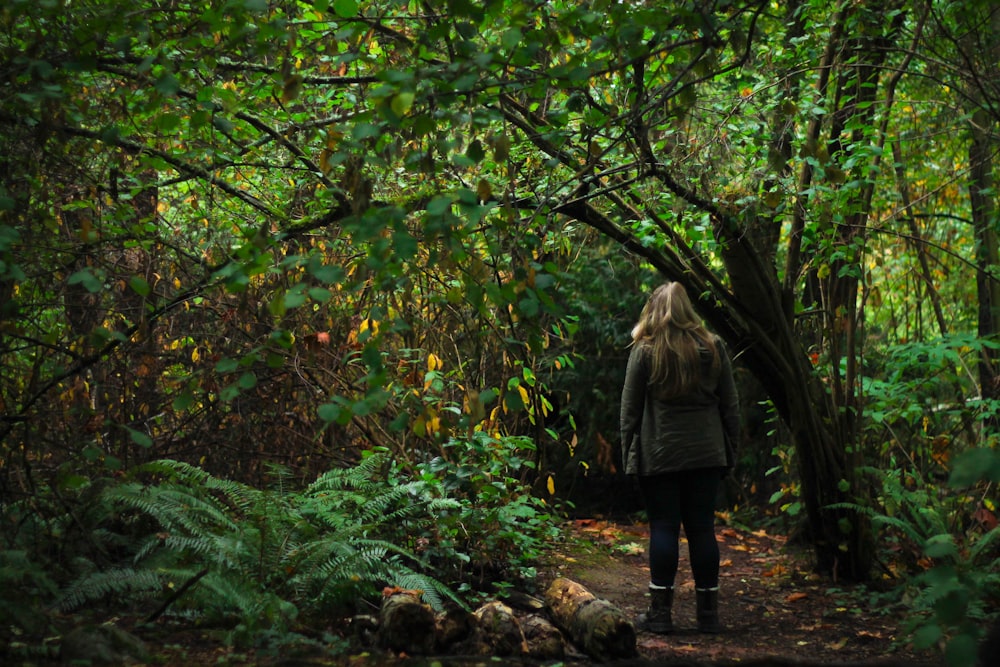 woman walking in the middle of forest