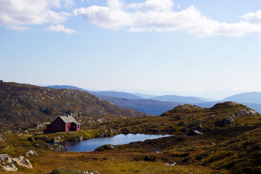 red house near body of water