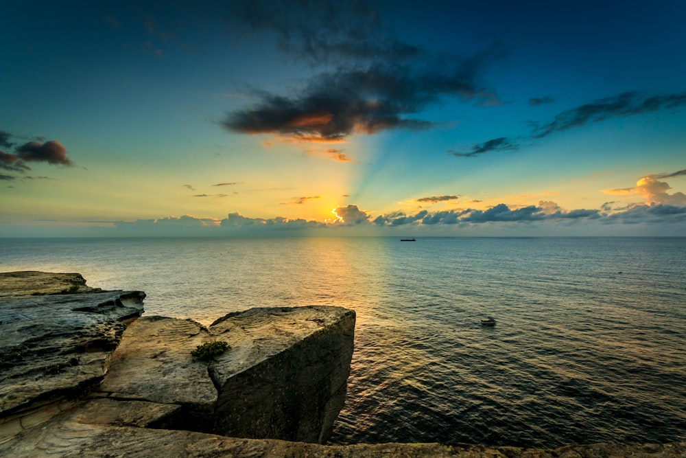 Die Sonne geht von einer Klippe über dem Meer unter