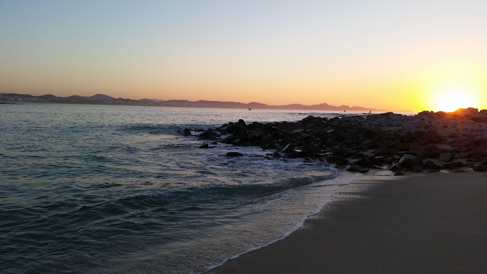 beach with rocks during golden hour