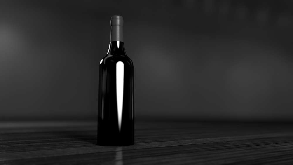 black glass bottle on brown surface