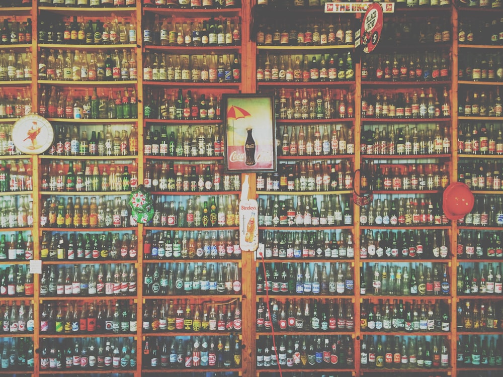 coke bottle poster with brown wooden frame on brown rack