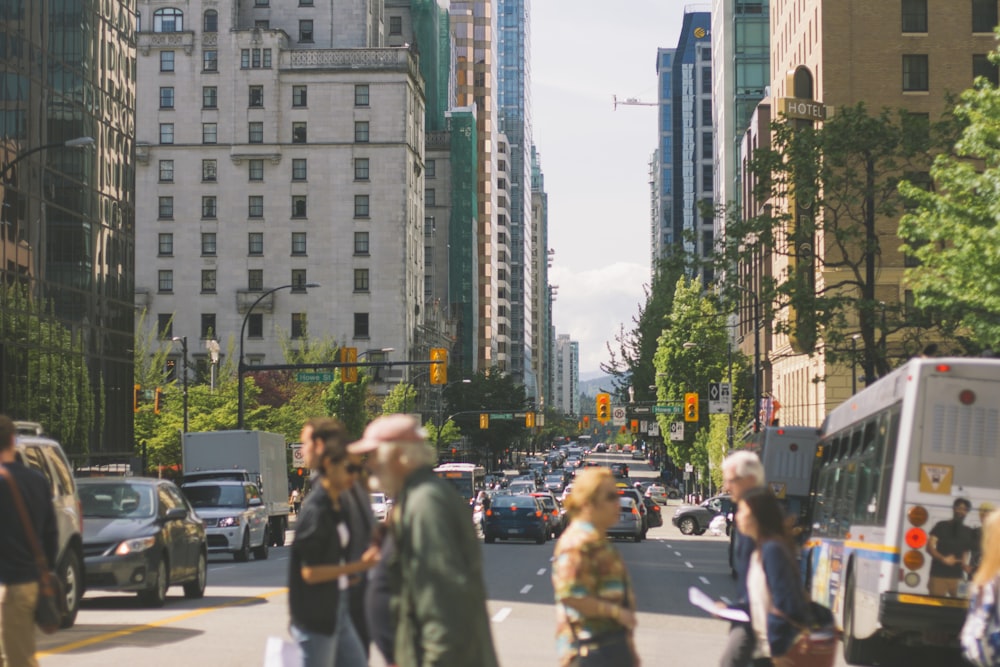 people crossing gray road