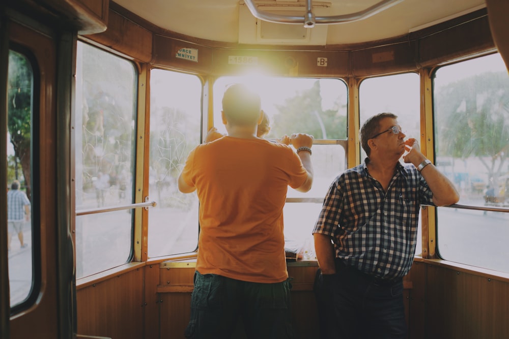 men standing inside of train