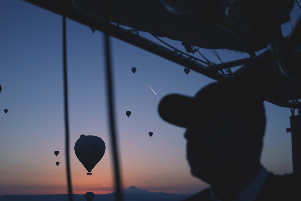 silhouette of person with hot air balloon in the air