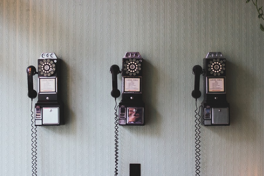 A set of vintage telephones hang on a wall.