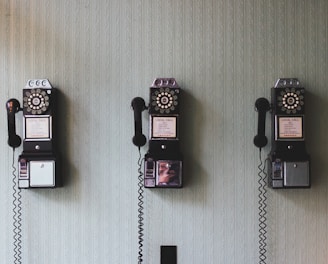 minimalist photography of three crank phones