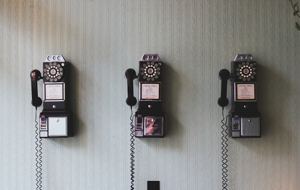 minimalist photography of three crank phones