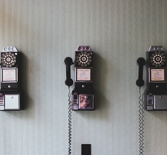 minimalist photography of three crank phones