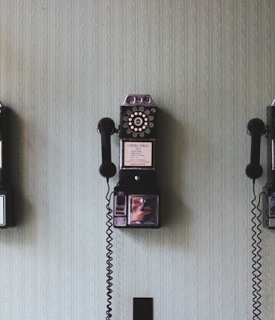 minimalist photography of three crank phones