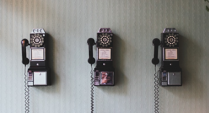 minimalist photography of three crank phones