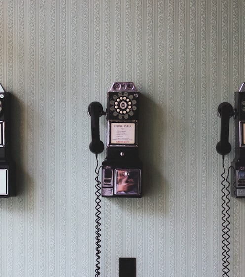 minimalist photography of three crank phones