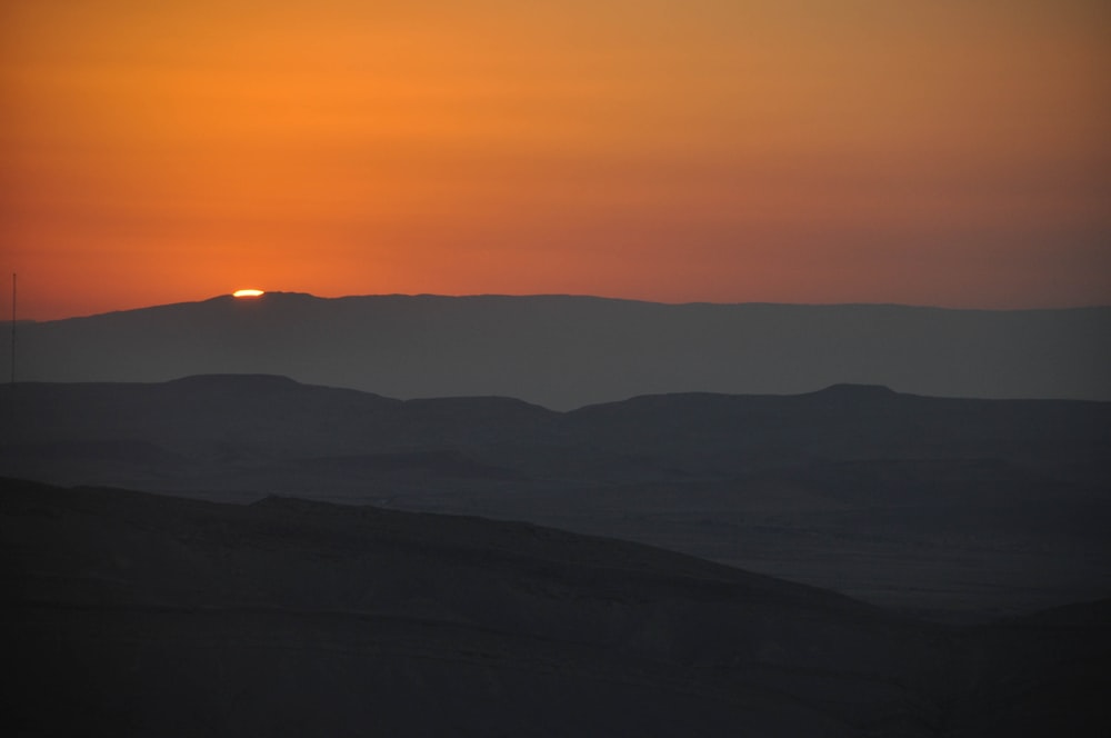 silhouette photography of mountain during senset