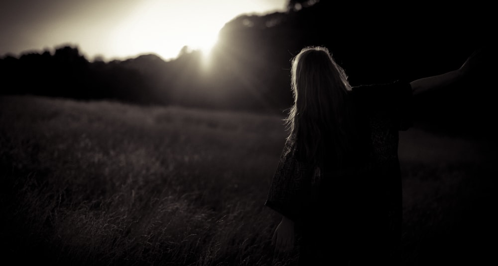 woman walking on grass field