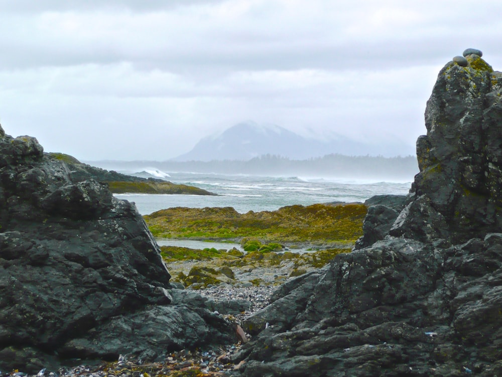 gray rock formations in front body of water