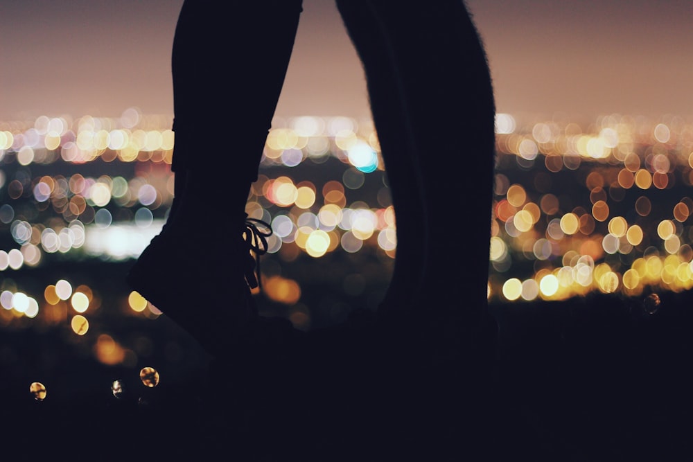 silhouette of two person standing in front of each other