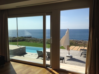 Wide view of a patio with multiple aluminum folding doors fully opened to the outside.