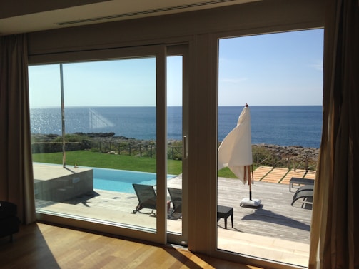Wide view of a patio with multiple aluminum folding doors fully opened to the outside.