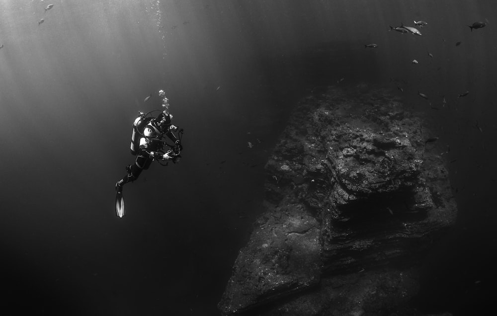 grayscale photo of person scuba diving