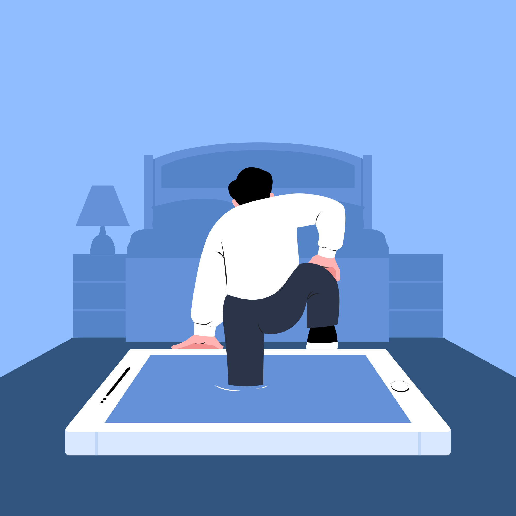 A man sitting on a tablet in front of a couch