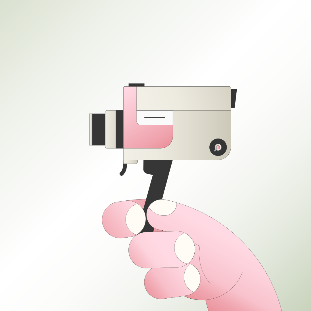 A hand holds a vintage camera.