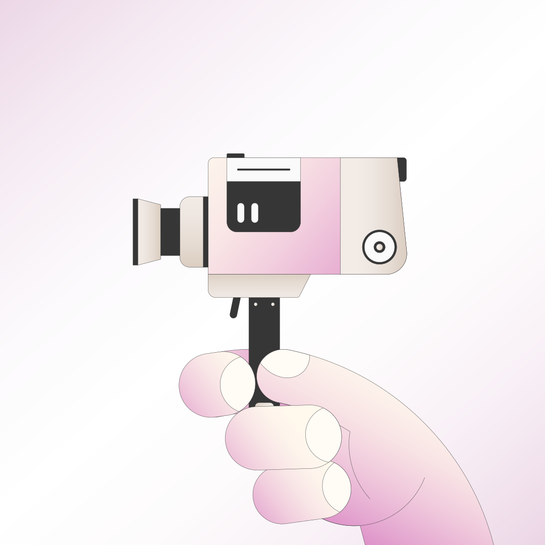 A hand holds a retro pink video camera.