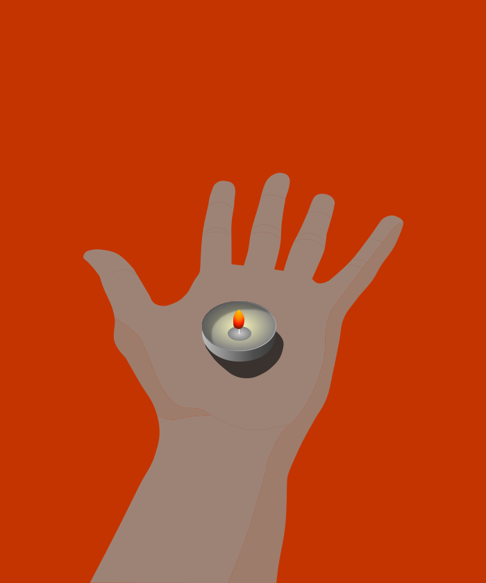 A lit candle held in an open palm.