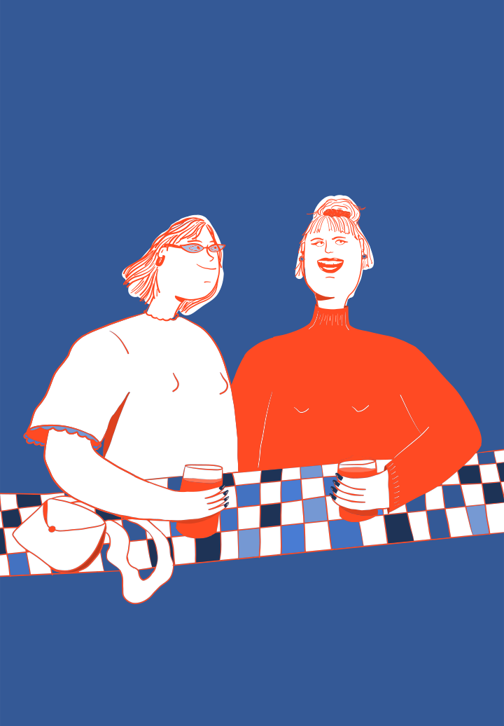 Two women with drinks at a checkered bar.