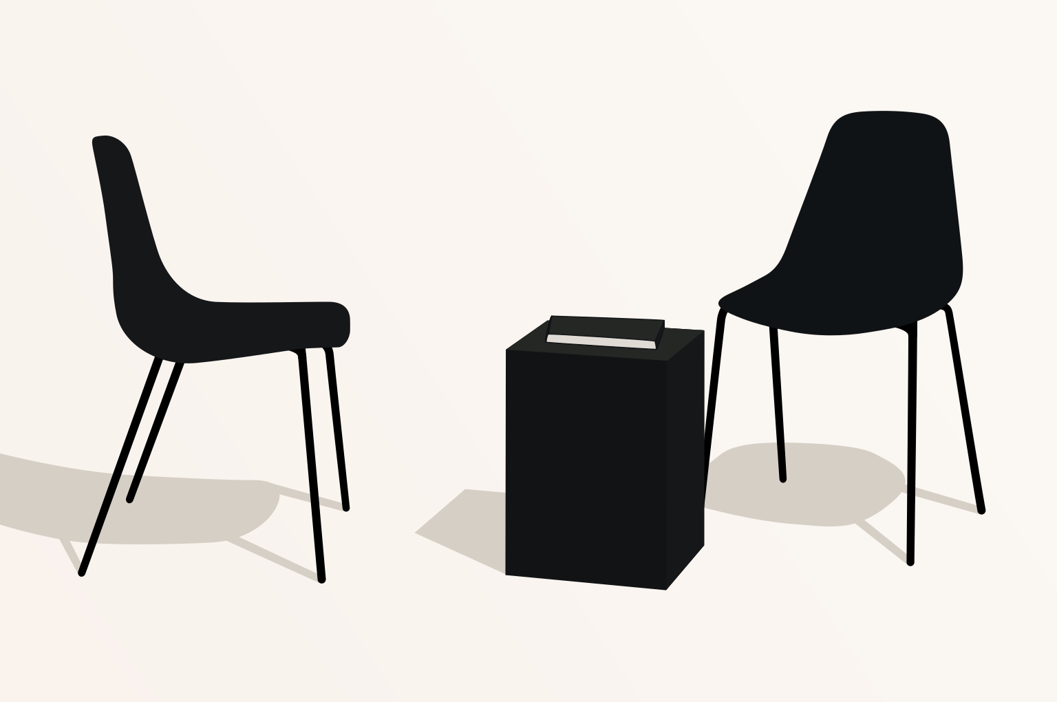 Two black chairs facing a black table.