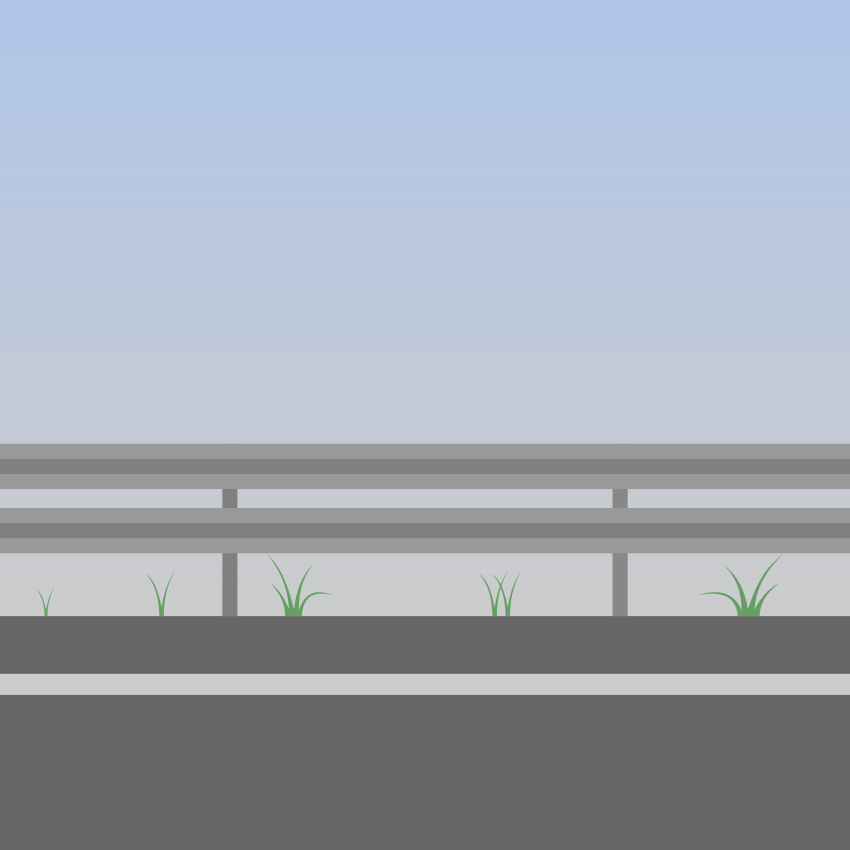 Guardrail along a road with sparse grass