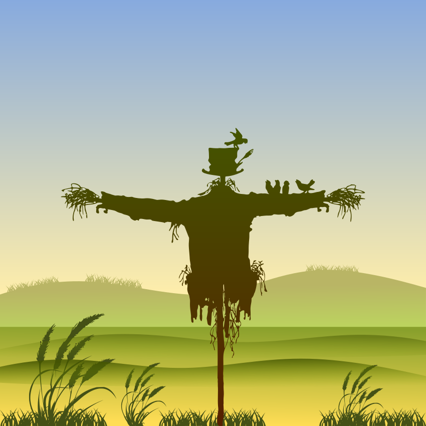 Épouvantail dans un champ avec des oiseaux sur les bras