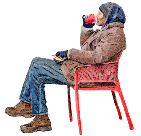 Person in warm clothes drinking from red mug