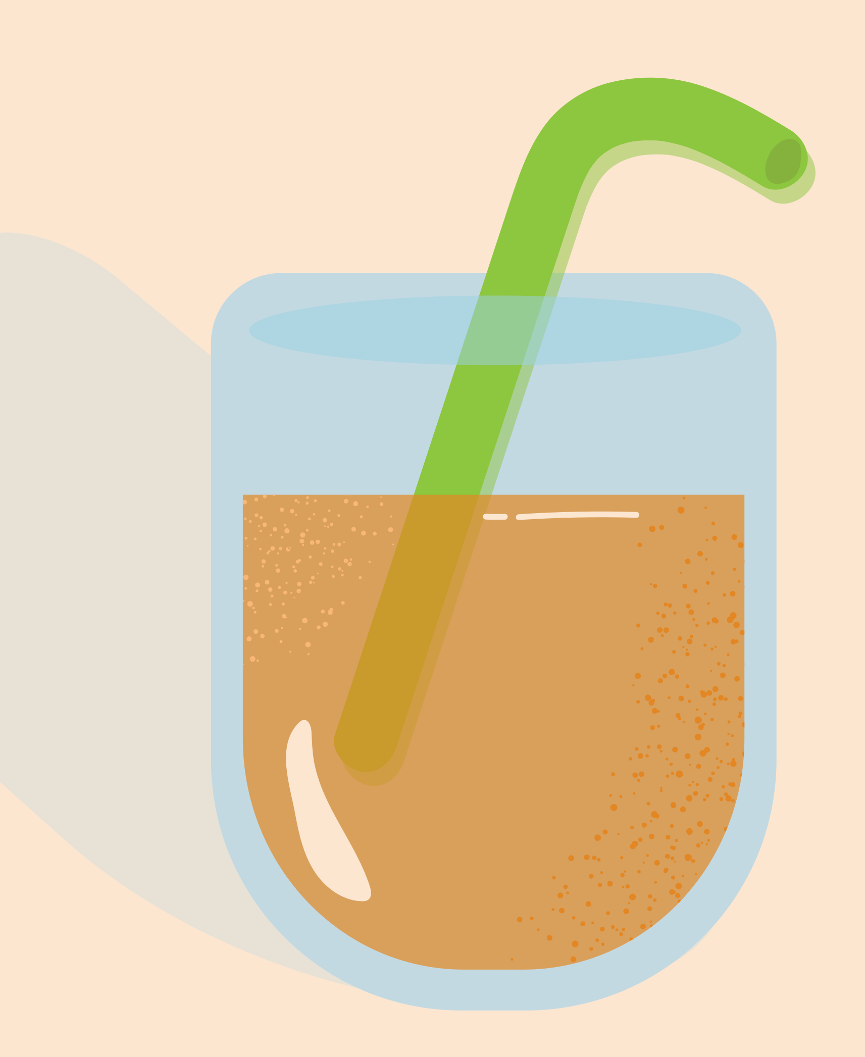 Glass of orange juice with green straw