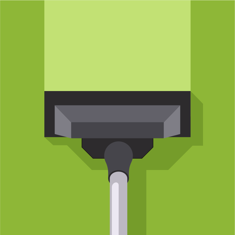 Cabeza de aspiradora limpiando una superficie verde