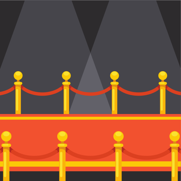 Red carpet event with gold stanchions and spotlights