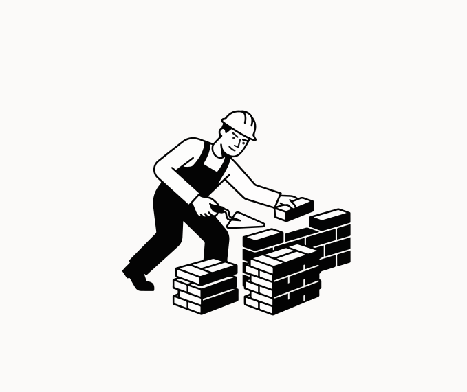 Construction worker building a brick wall with trowel