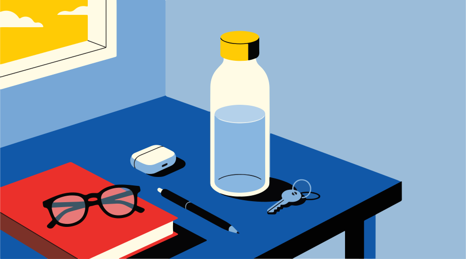 Desk with book, glasses, water bottle, and keys