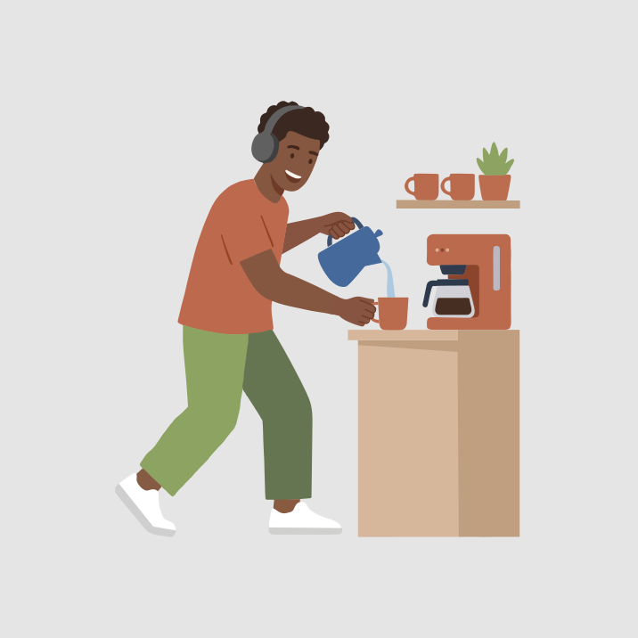 A man with headphones pours water into a coffee maker.