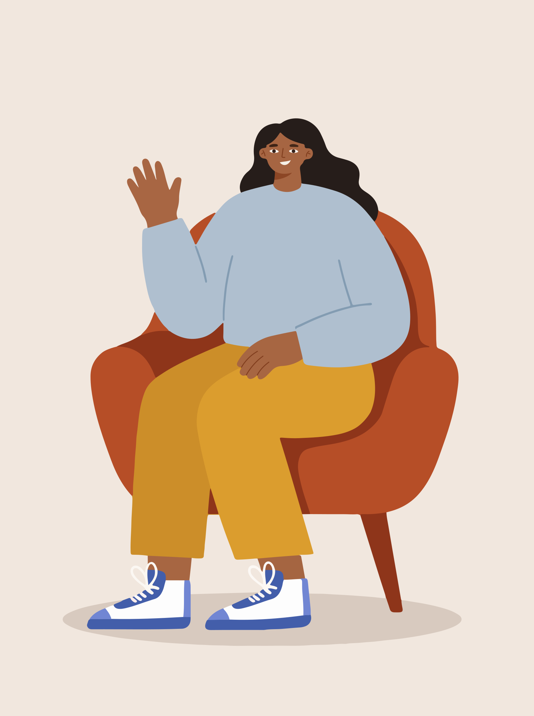 A woman waves hello while sitting in a chair.