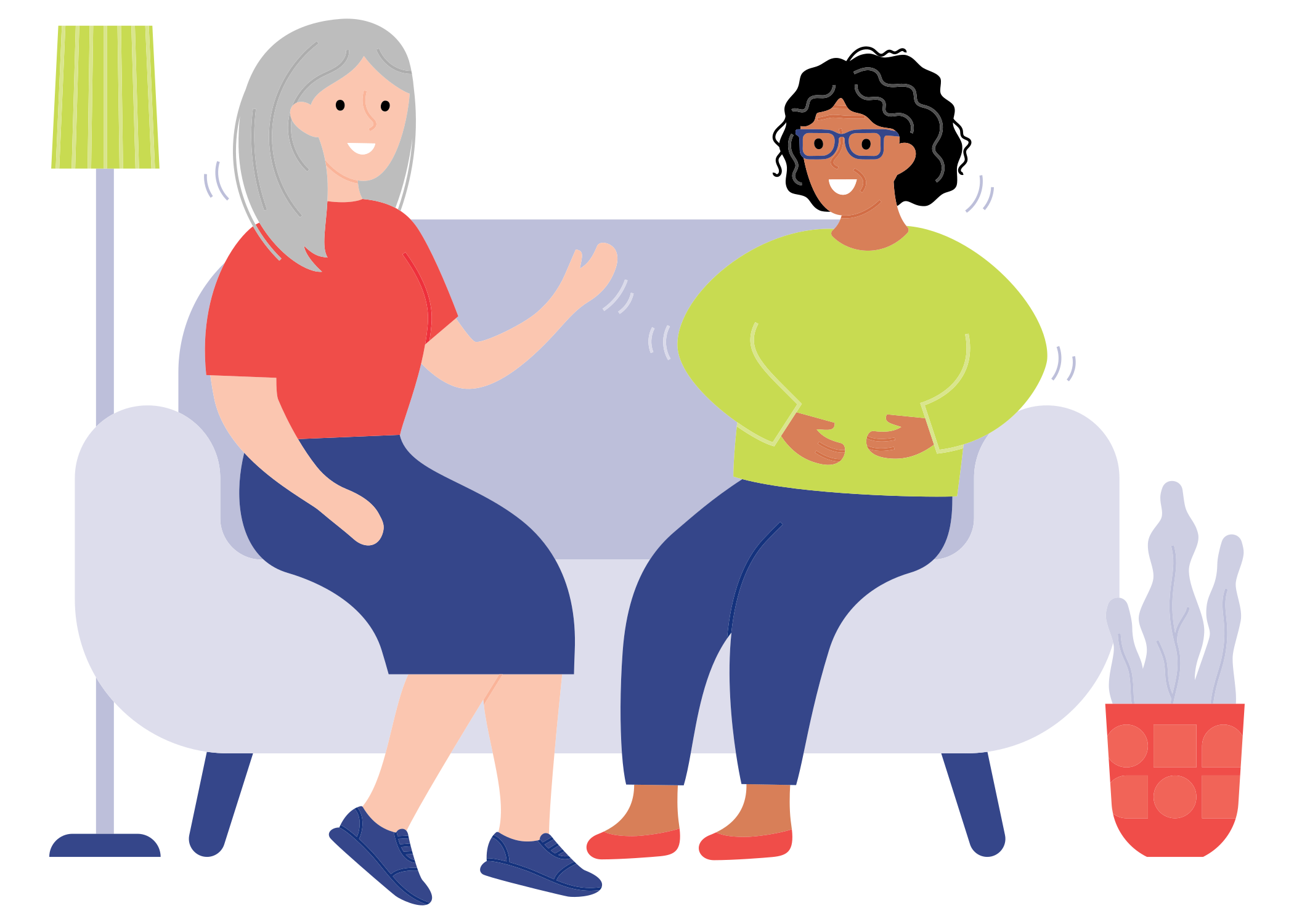 Two women talking while sitting on a couch